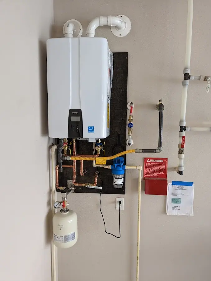 Professional plumber installing copper piping in a East Bradford home